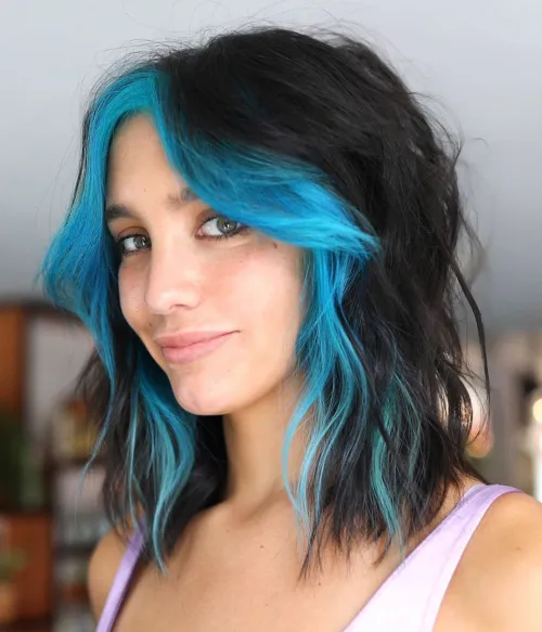 Dekle z neonsko modrimi prameni v E-girl stilu.